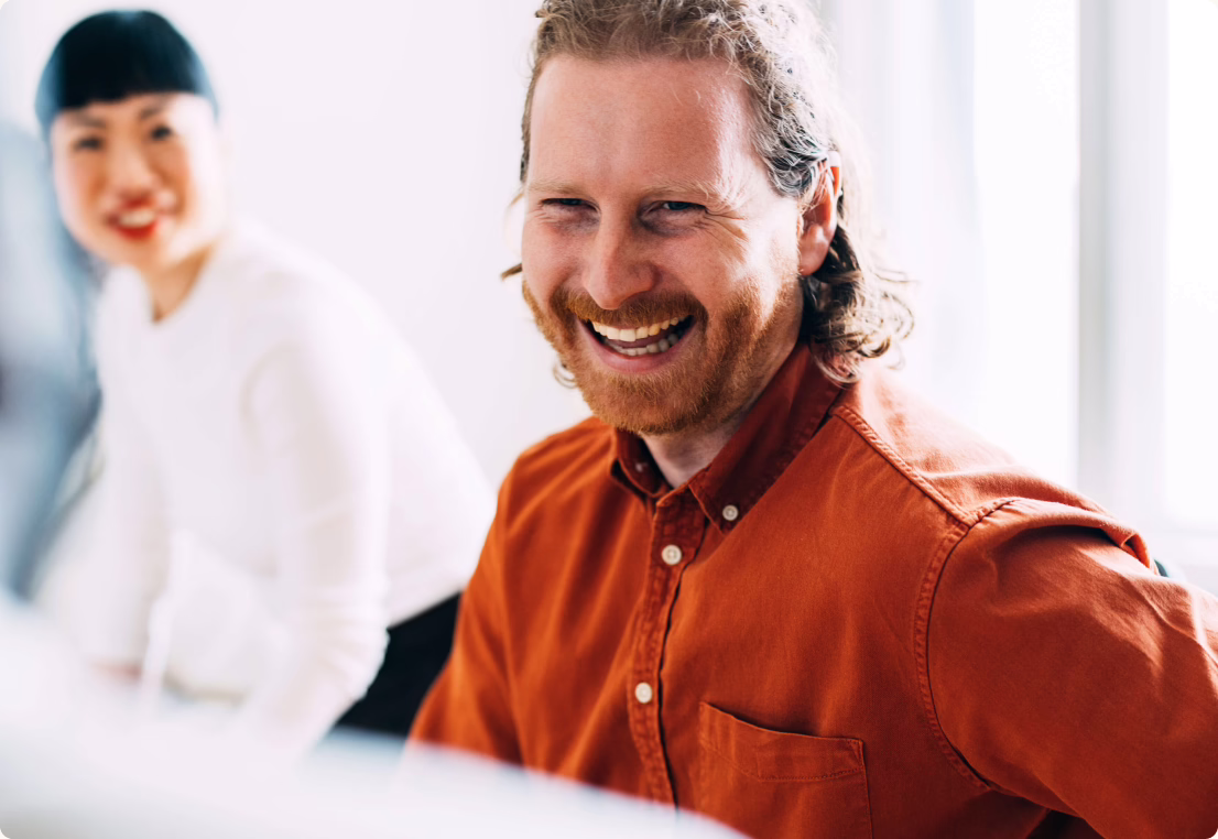 Vital Incite team members collaborating and laughing in the office